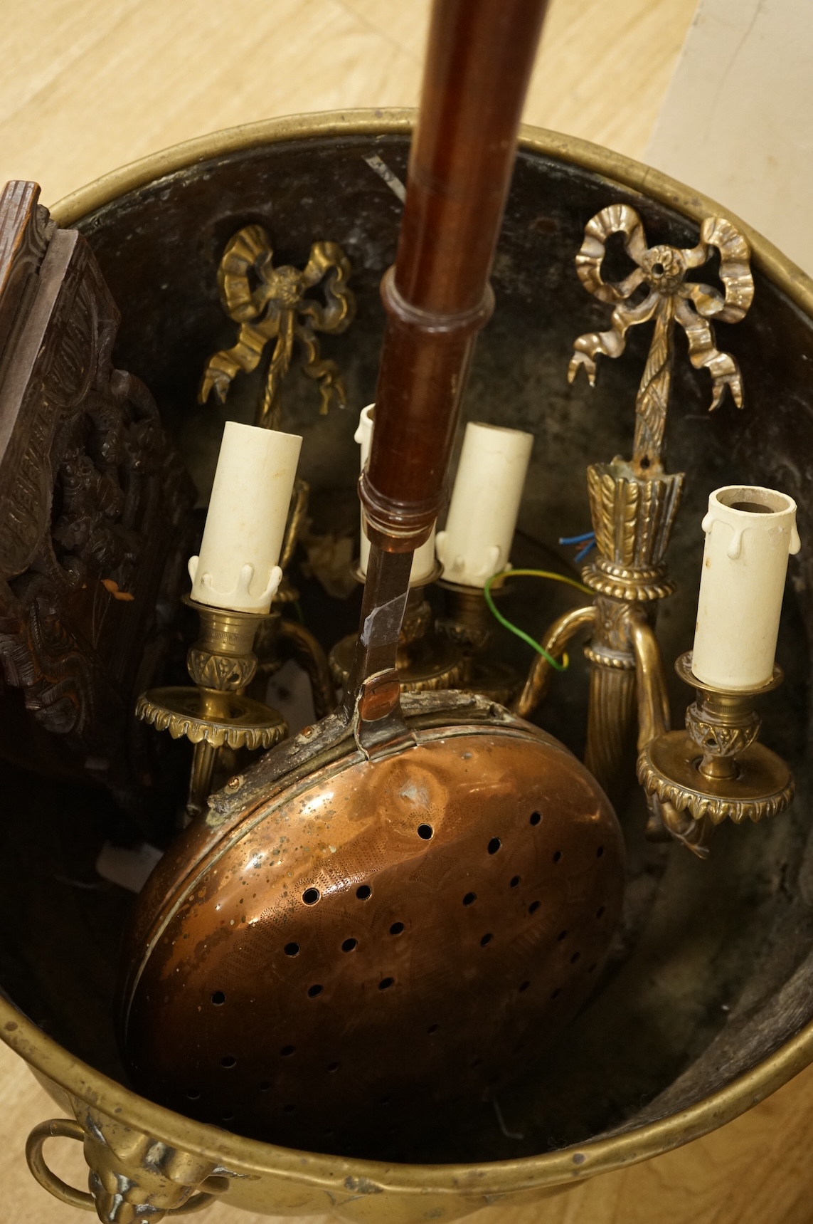 A 19th century Dutch brass coal bin, a pair of wall sconces, a copper bed warmer and three book slides